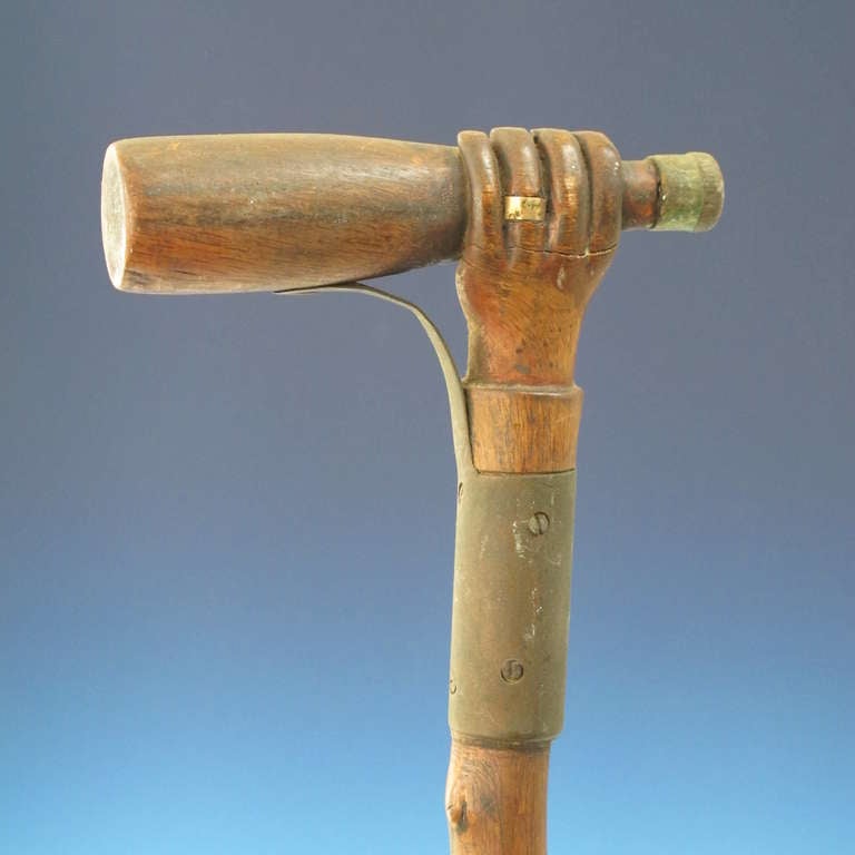 American Hand Holding A Bottle Carved Cane For Sale