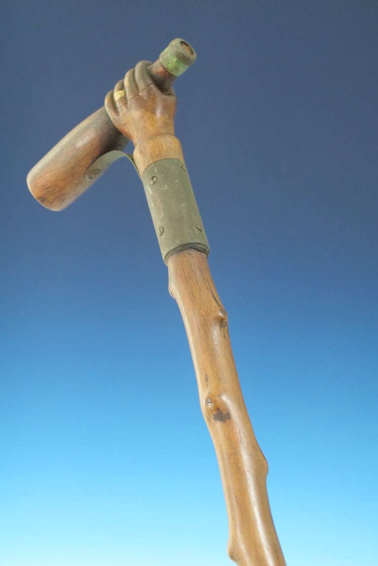 Folk Art Hand Holding A Bottle Carved Cane For Sale