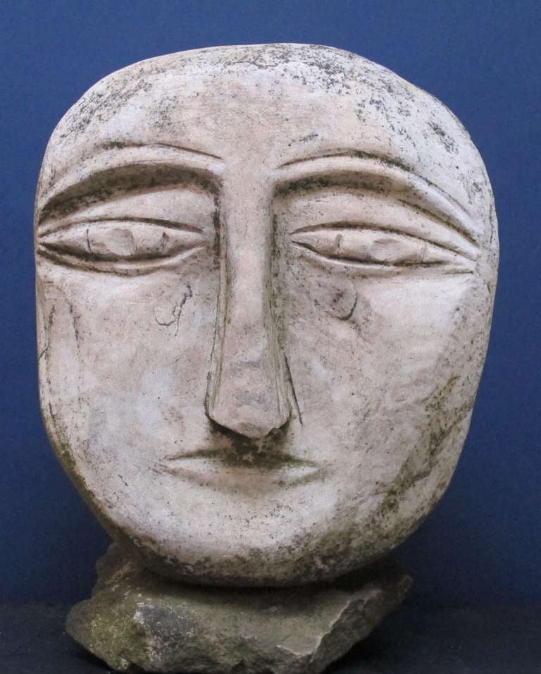 Sandstone head sculpture by self taught artist Ted Ludwiczak.
Ted Ludwickzak began carving stone heads in 1988 after retiring from grinding contact lenses. He is known for his stone heads environment and has been featured in numerous