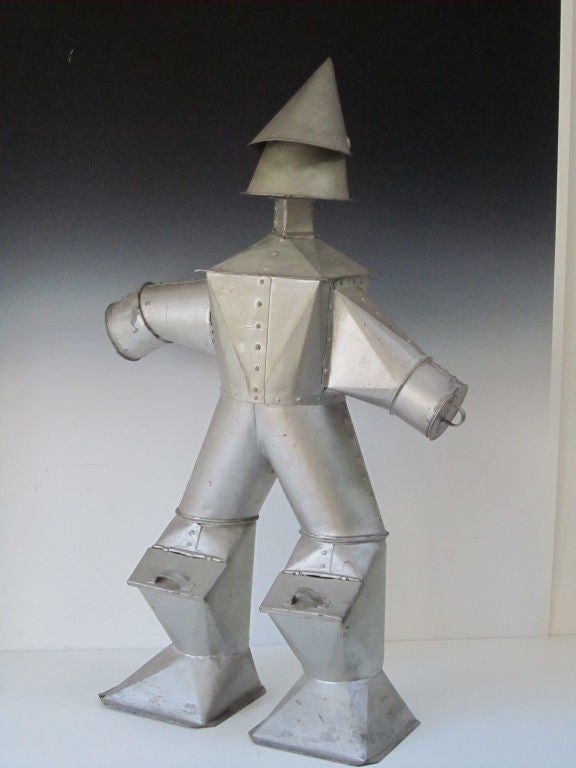 One of the earliest tin men made by Israel Zachvitz, Bronx, NY 1925.  The legs have little doors that hinge open and inside was found a yellowed note with the name and address of the maker and his tin shop.  This is one of the earliest tin men known