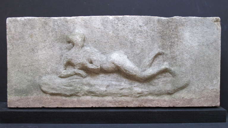 Architectural marble relief of a shapely woman. The textured stone shows outdoor weathering either from a building or garden. Found in St. Louis.
Mounted on a modern black wood base.