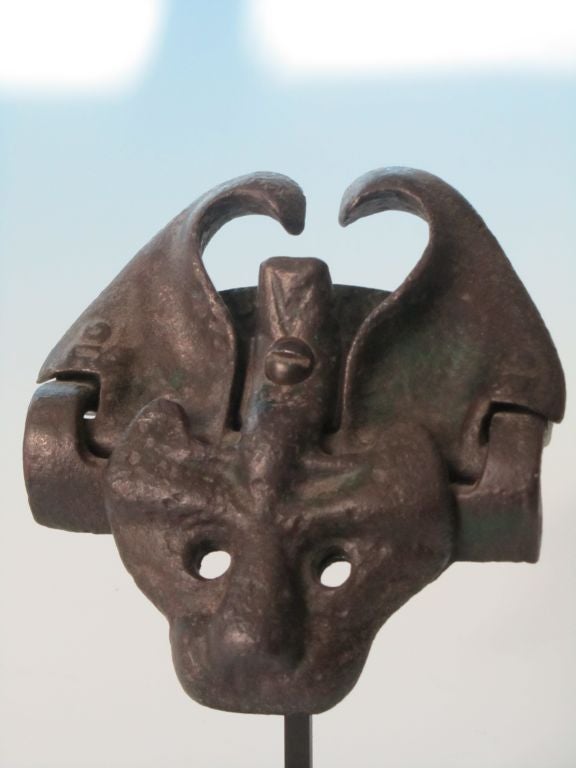Cast iron cat face with movable ears to open and latch a gate. Marked Patd. Sept 13, 1895 under ears.  Mounted on American Primitive base at an angle.