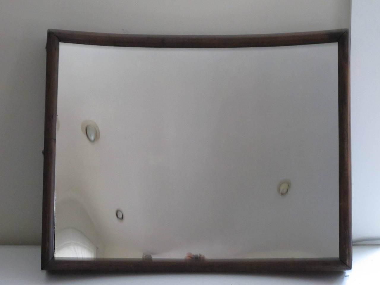 Small size fun house mirror with concave glass mirror set into wood frame. The mirror can be hung either vertically or horizontal for different image bending of light. Most trick mirrors I have seen are huge and unwieldy.