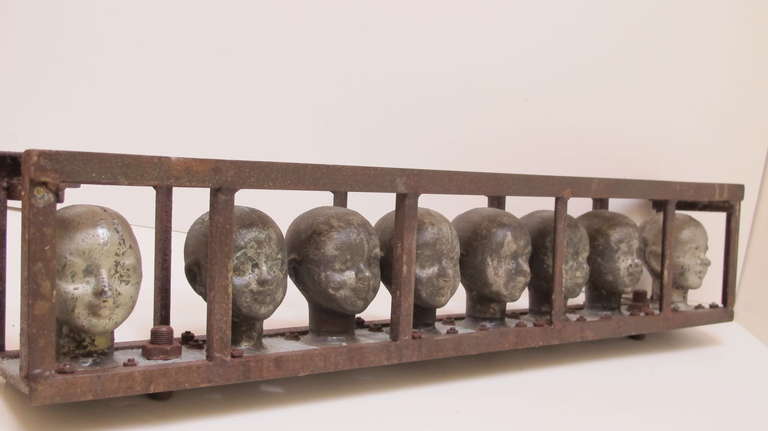 American Doll Head Molds in a Metal Frame