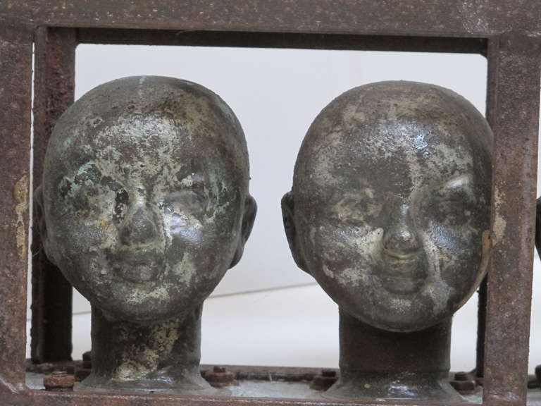 Copper Doll Head Molds in a Metal Frame