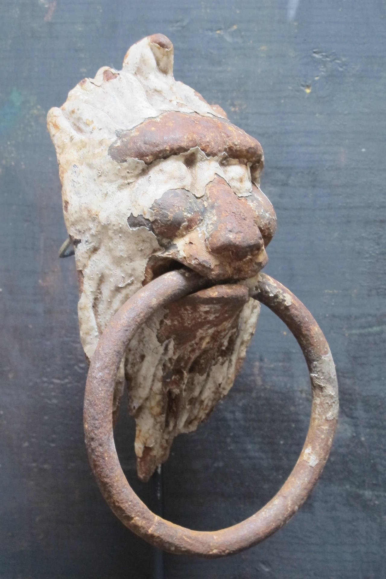Old cast iron door knocker with remains of old paint (removable) and iron ring knocker. Can be mounted on a door or displayed on its black metal stand.
Dimensions: Height on base is 12 inches, 19th century.