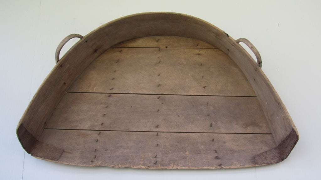Graphic piece made of bent wood connected to a shaped wood bottom with a pair of bent wood handles on the side. A large and early harvest piece essential for separating the grain from the husks. It hangs dramatically from a wall especially with high