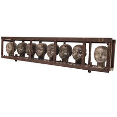 Doll Head Molds in a Metal Frame