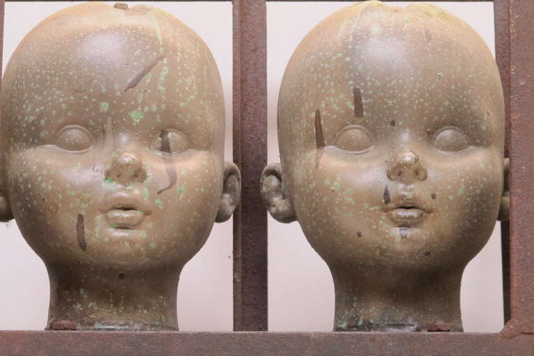 Mid-20th Century Series of Large Doll Head Molds in Iron Frame