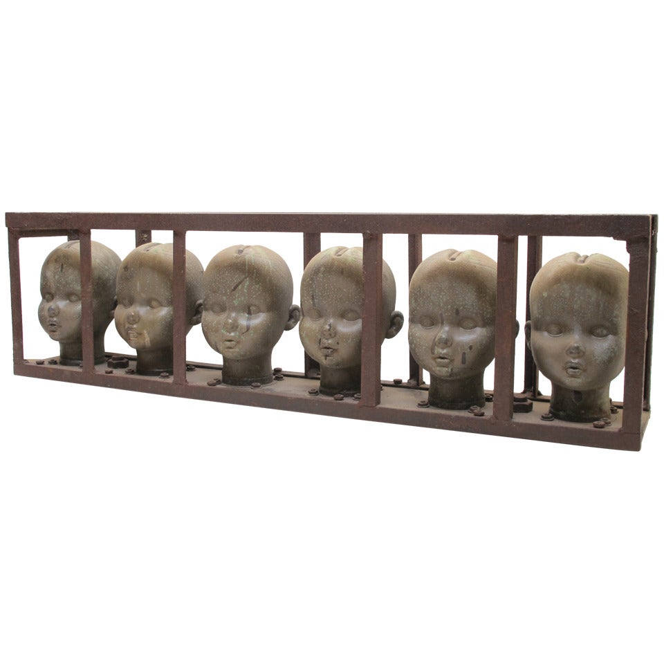 Series of Large Doll Head Molds in Iron Frame
