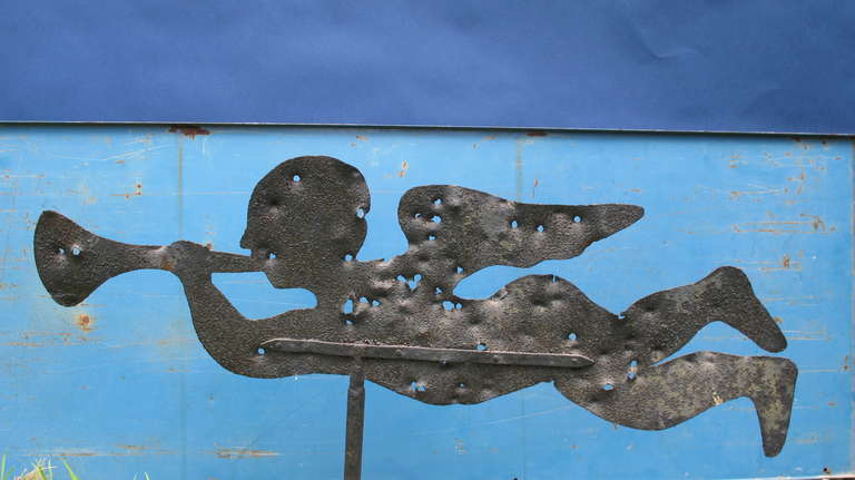 Sheet iron Angel Gabriel blowing his trumpet was once on top of a building near Stratford, Ct. The angel is a survivor of someone taking shots in order to make it spin.We do not charge extra for the holes. A metal base or wall bracket is available