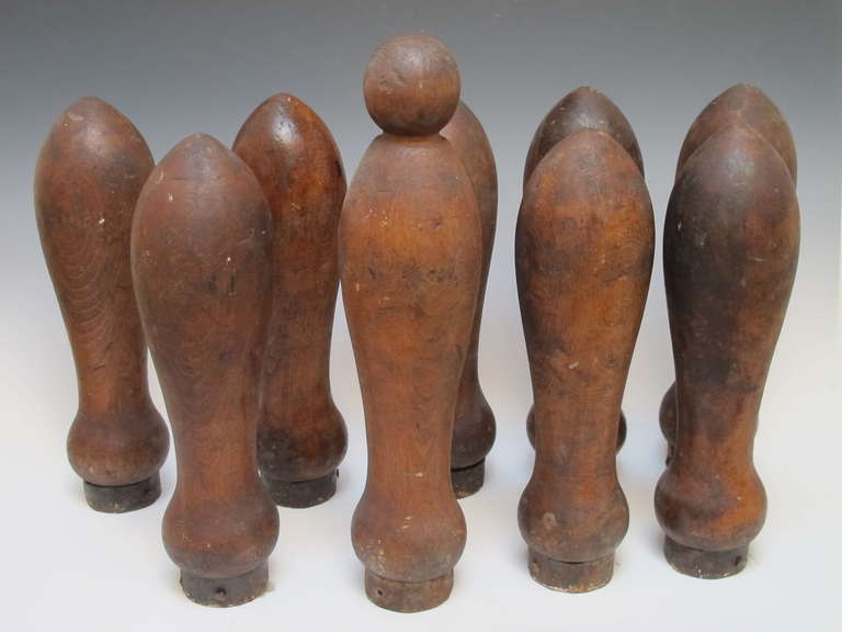 Set of 9 turned wood bowling pins with 2 wooden balls.The pins have an old untouched surface with iron rings on the bottom.The set came in a wooden box. Probably used in lawn bowling in the late 19th c. They set up as sculptural objects.