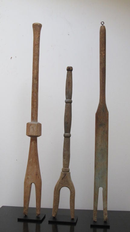 Before washing machines women used these hand carved laundry sticks to stir and lift out the clothes from tubs of scalding water. I have collected the minimal figural forms with many variations of form. This is an especially nice group. Ht 30, 23,