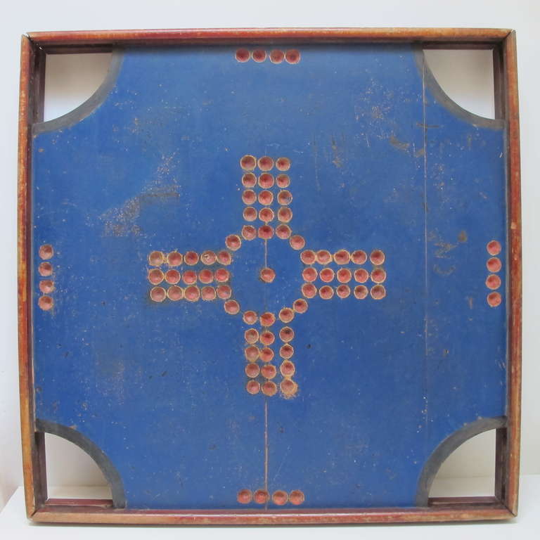 Painted wood panel in frame with cut out corner pockets. The reverse side of the game board is the game of crinokle.