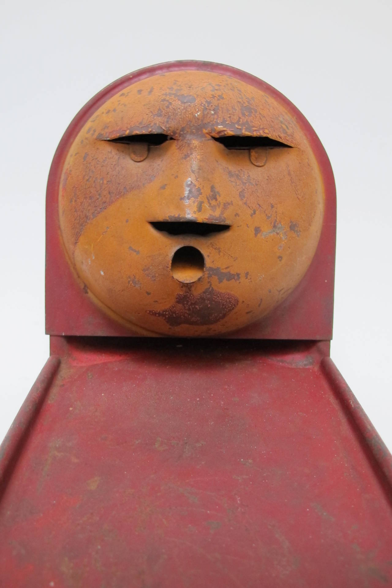 The moon face is the target for the shooter of metal balls. The ball goes under the moon and up the curved back and fall through the holes in the eyes, nose or mouth. There is the remains of an old maker's label which is unreadable.