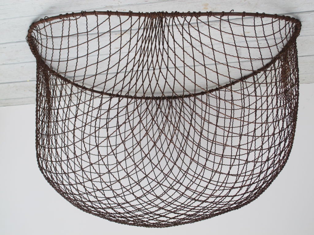Artistry in wire work that looks great on a wall or has a sculptural presence on a floor or table.  The heavy gauge crinkled wire is gridded in dimensional space to let light pass and create great shadows. Can be hung on a screw on the wall as an