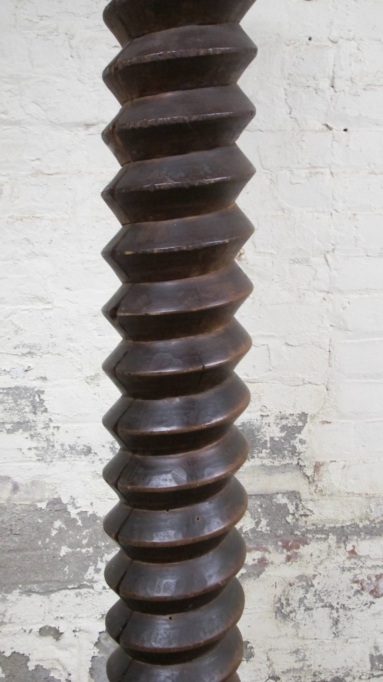 Totemic tall wood wine press screw mounted on metal base. Wood screw posts such as this were seen in Brancusi's studio in Paris. This is an unusually tall one with a dark stain and patina from use. Probably from Spain or Portugal.