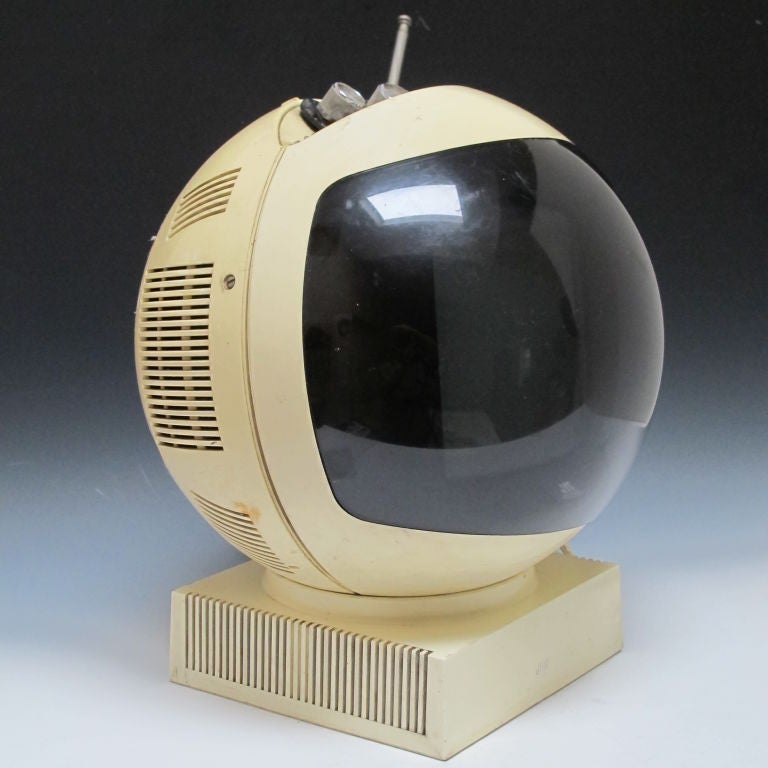 Television shaped in the form of a space helmet.  An iconic design of the 1970s inspired by the film 2001: A Space Odyssey.  JVC black & white TV that lifts off base and has a chain carry handle.  Working condition.