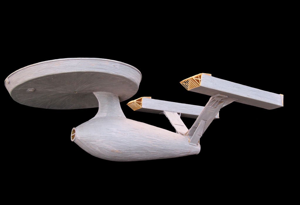 Large Starship Enterprise from Star Trek constructed entirely from wooden matches painstakingly glued together and painted. Made by a man in Maine during the long winters.  It looks amazing suspended or could be mounted in flight.