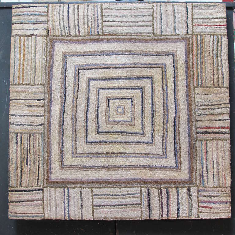 Remarkable abstract hooked rug in earth tones.
The linear geometric pattern related to the work of a number of abstract artist from the 2nd half of the 20th c.but was created in the 1920s by an unknown artist. Mounted on fabric stretched over frame