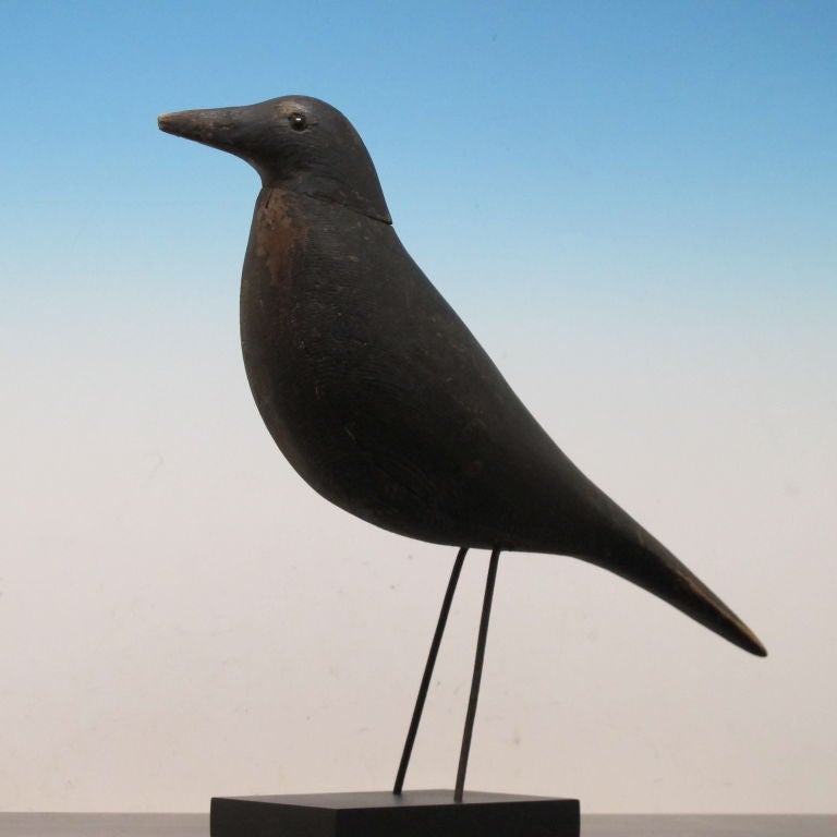 An early solid body crow decoy by Charles Perdew (1874-1963) from Henry, Illinois. Charles Perdew was known for his fine stylized crow carvings with metal legs and glass eyes as well as carving other prized decoys.