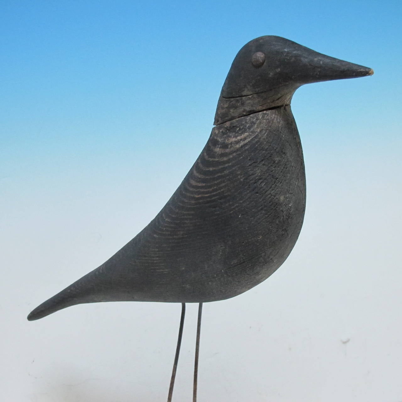 Charles Perdew (1873 - 1963) was known as the greatest carver of Crow decoys. He lived in Henry, Illinois which was an area where crows were plentiful, trouble for farmers with crops, and an eating delicacy for some. This solid wood crow decoy was