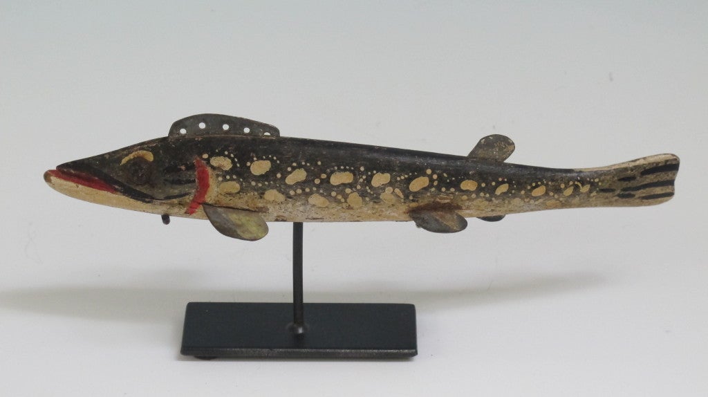 Exceptional painted fish decoy carved by Oscar Peterson (1894-1951) from Cadillac, Michigan. Peterson was a guide and a master in carving and painting many of the fish decoys that he and others used to pursue fish in winter through holes in the ice.