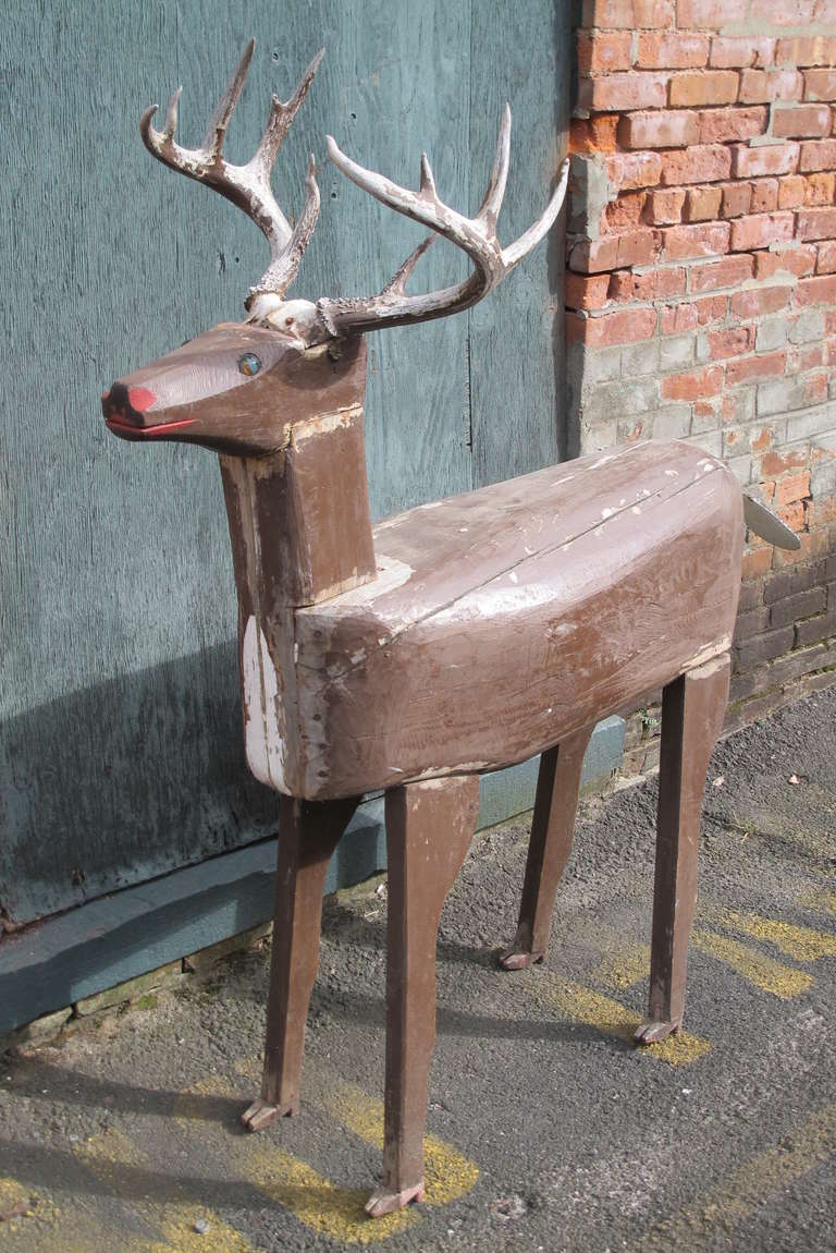 Wooden deer folk yard art with applied antlers. This deer originally came out of a Maine yard show and has since retired  indoors.It has a presence inside or out. It was made in parts with the head joined to the neck and legs joined separately. The