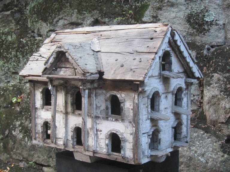 This martin birdhouse is a survivor from many generations of bird families.
It is of pieced wood and with multiple apartments with perches at many of the arched doors. I sold this birdhouse in our first birdhouse show about 20 years ago. It has
