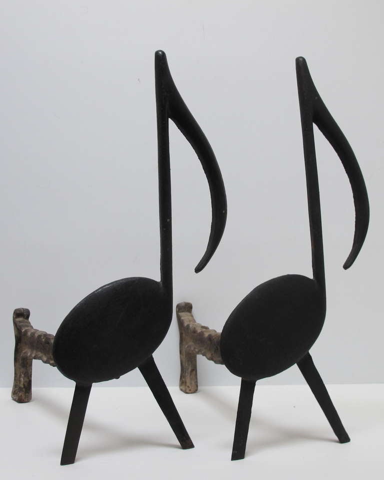 Graphic pair of cast iron music notes with removable log holder supports for the fireplace. Stamped Tenn Chrome Plate Co. 
Nashville.