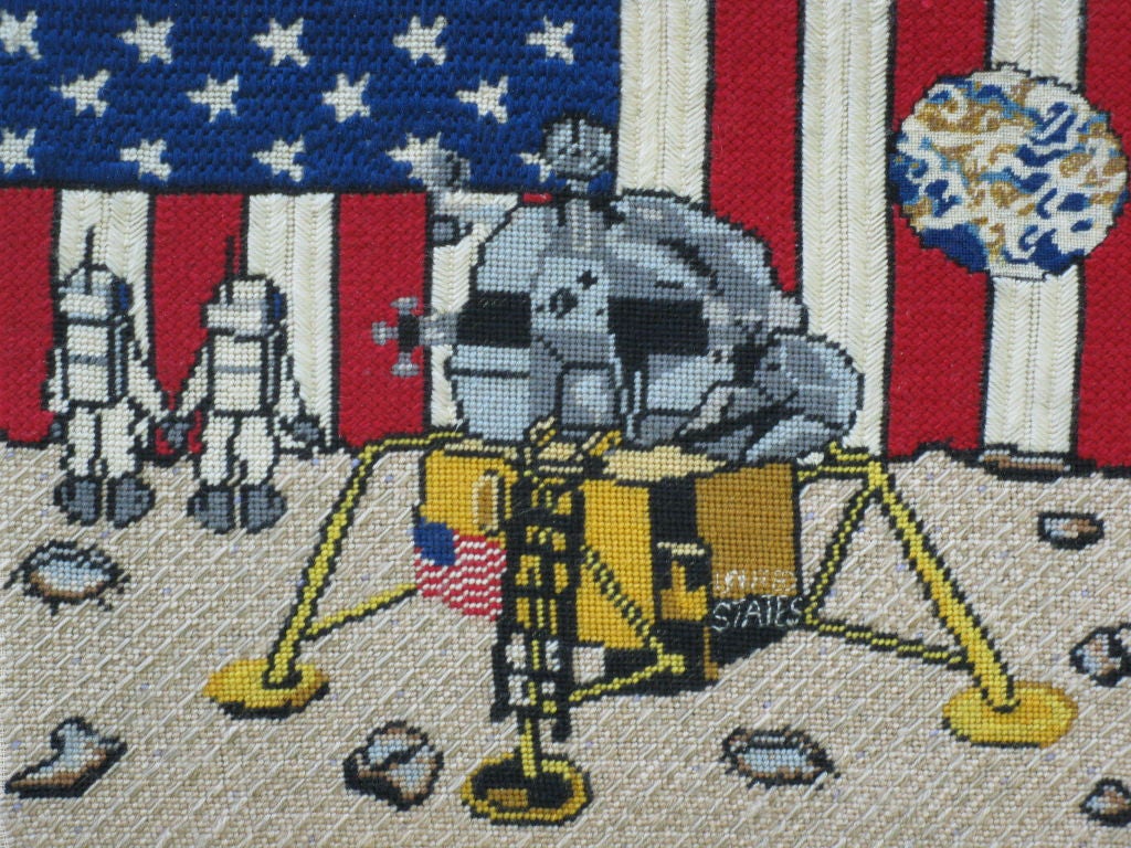 Yarn sewn picture on cloth backing of the first men on the moon<br />
with Lunar Lander and Earth in the distance with American flag backdrop. Celebrating America's astronauts setting foot on the moon.