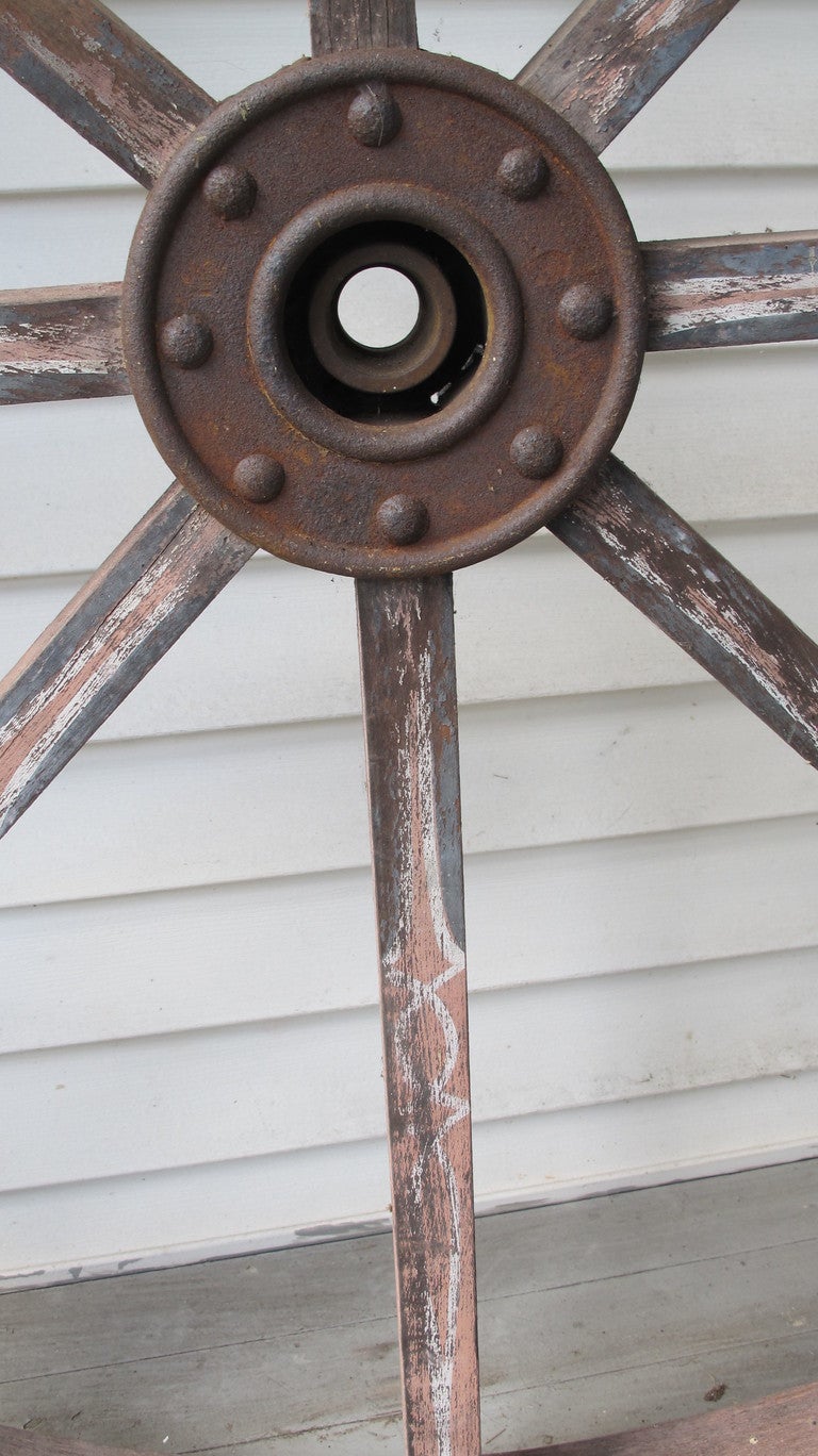 Wooden wheel from an early  mill in New Hampshire that was probably used to power tools. Fancy paint detailing on the spokes done by a sign painter. A leather belt would probably transfer power to a smaller wheel. Looks great on a wall.