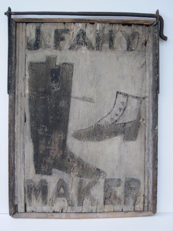 Early wood shoe makers sign with original forged iron hanger.  Framed wood panel painted on both sides similarly (one side more weathered).  New Jersey origin.
