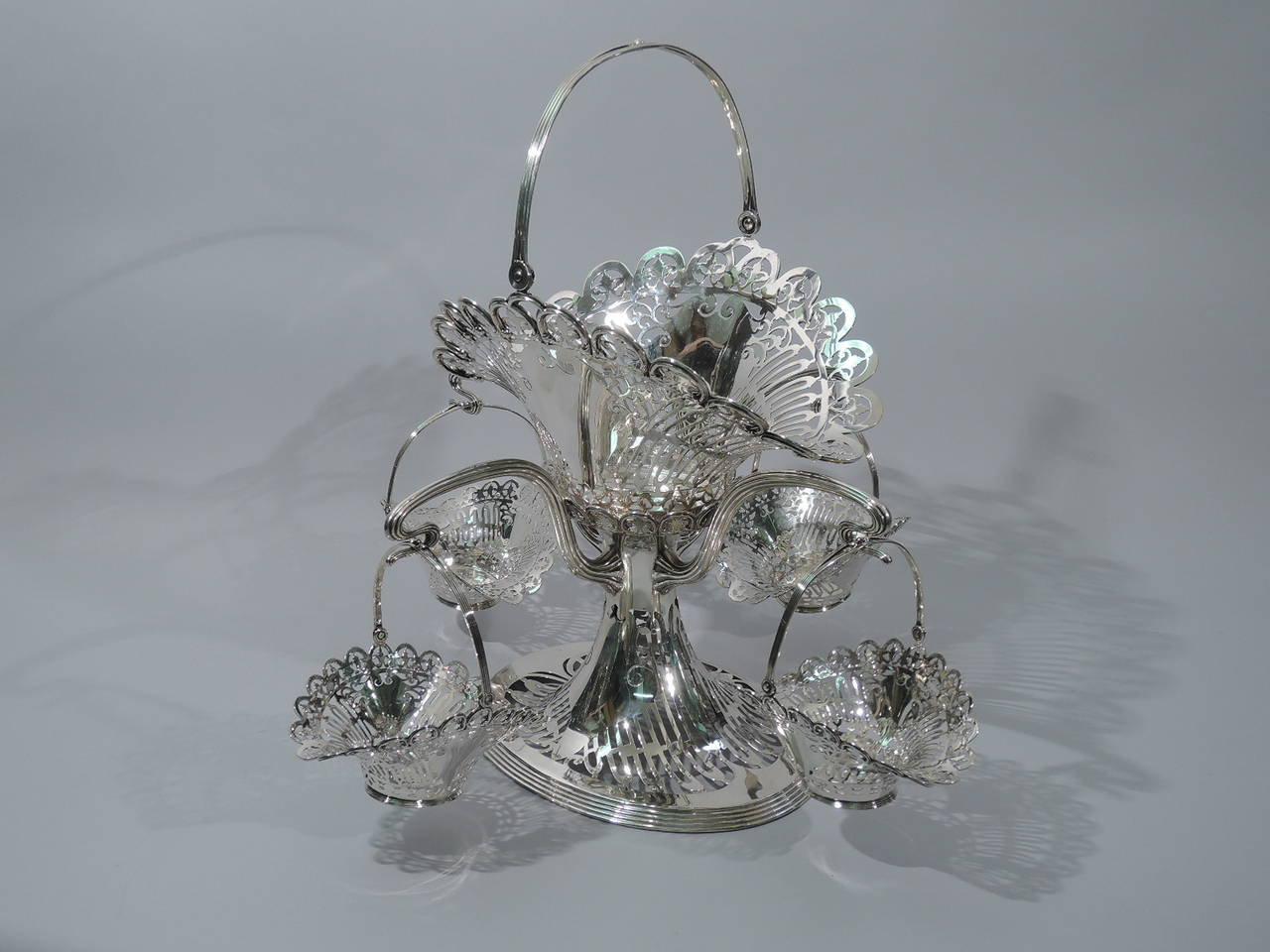 Beautiful sterling silver basket epergne. Made by Frank W. Smith in Gardner, Mass., circa 1910, for Bailey, Banks & Biddle in Philadephia. Raised base supports central basket and four reeded whiplash arms, each supporting same basket in