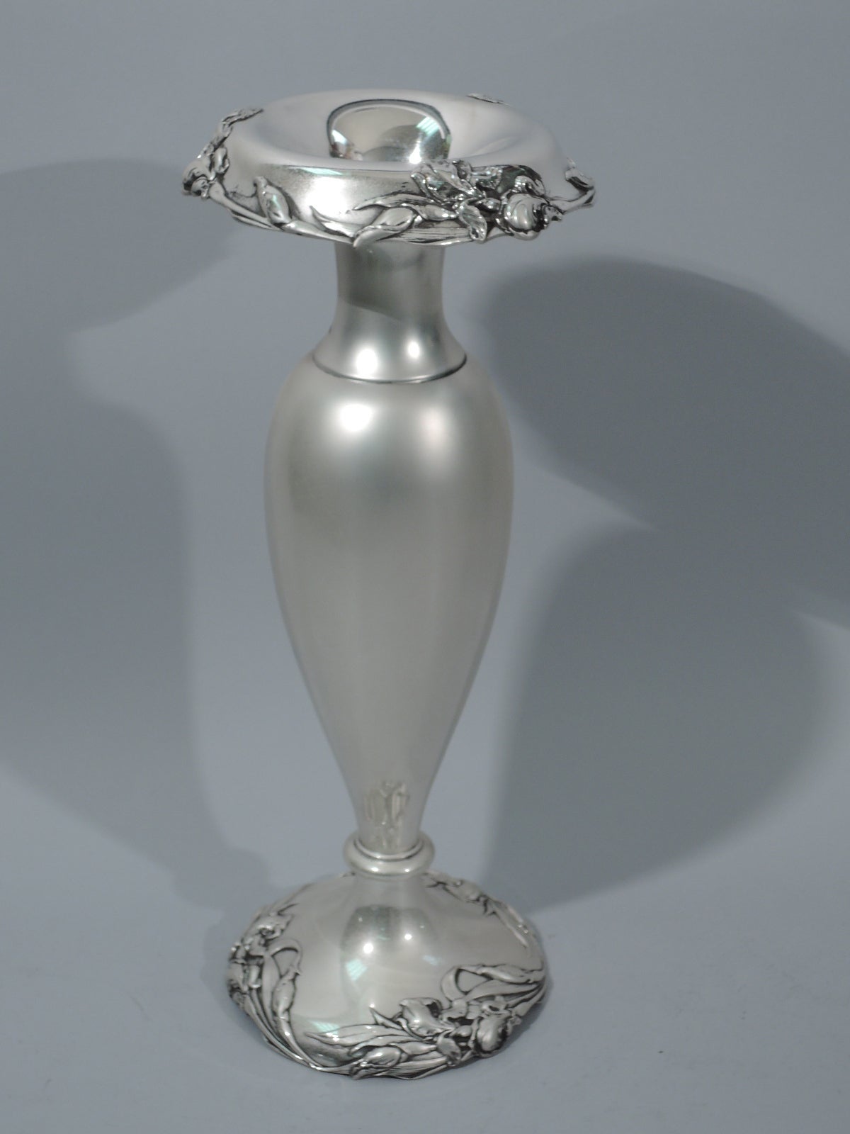 Art Nouveau sterling silver vase. Made by Reed & Barton in Taunton, Mass., circa 1900. Ovoid body terminating in knop on raised foot. Cylindrical neck, narrow mouth and turned down rim. Scattered flowers applied to rim and foot. Hallmark