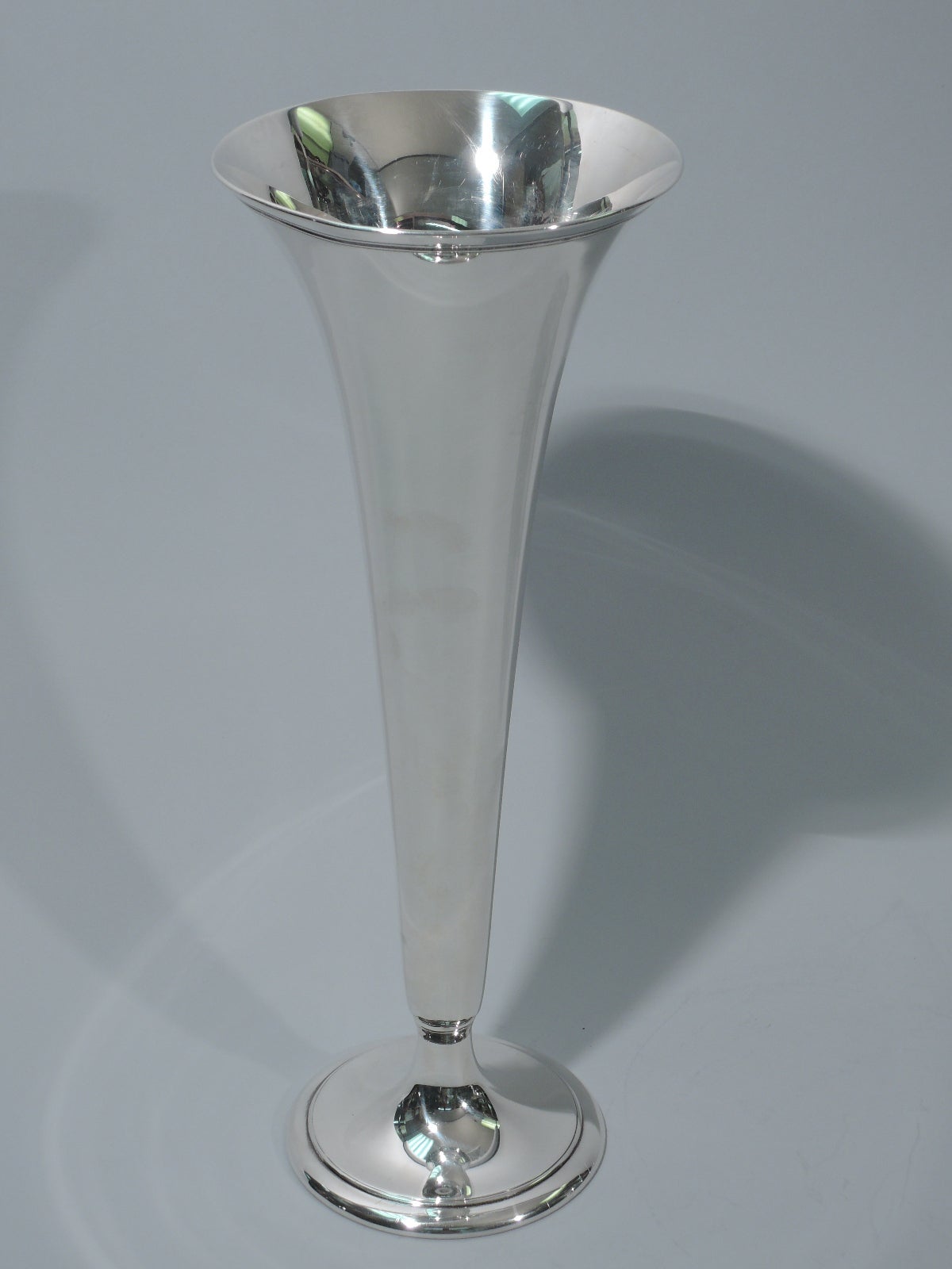 Sterling silver trumpet vase. Made by Tiffany & Co. in New York, ca. 1913. Flared rim and stepped and raised foot. Molded band near rim. Suggestion of knop at base. Subtle. The pattern (no. 18594) was first produced in 1913. Hallmarked. Excellent