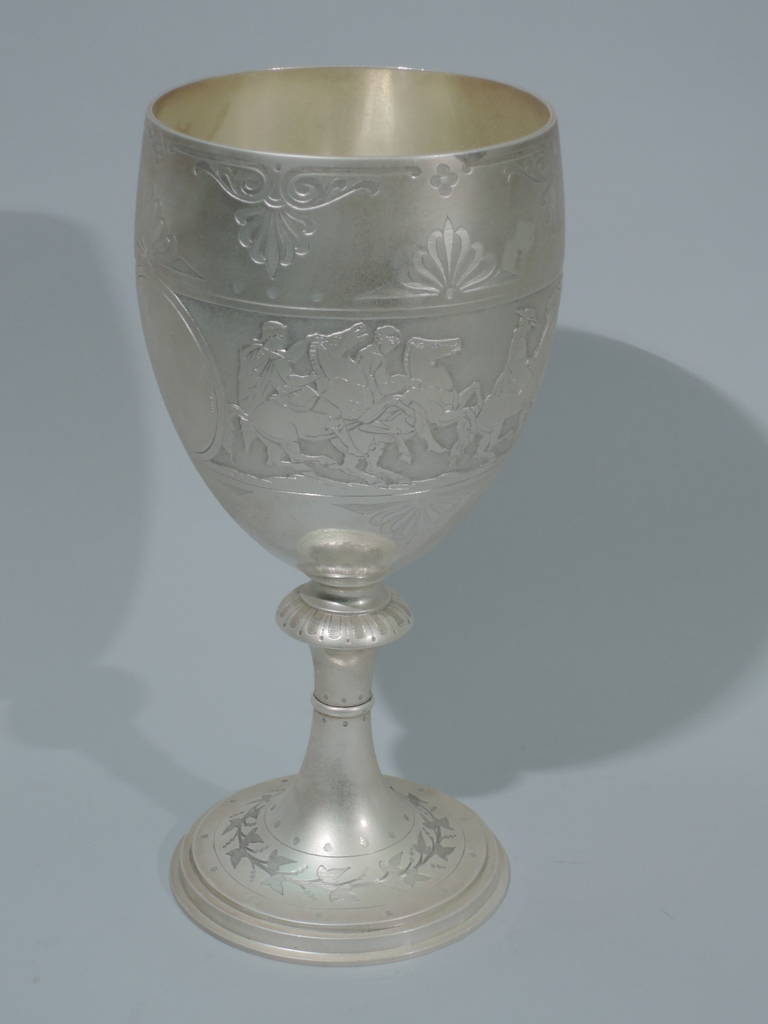 Large sterling silver goblet. Made by Barnard & Sons in London in 1872. Curved and tapering bowl on stem with flange and knop. Raised and stepped foot. Low relief frieze on stippled ground depicting a procession of Classical horsemen. Frieze