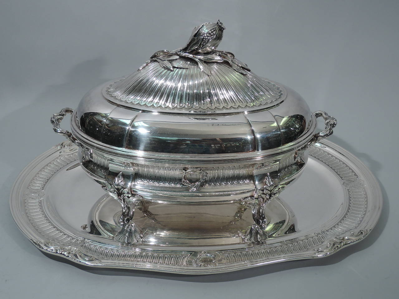 Rococo 950 silver covered soup tureen on Stand. Made by Christofle in Paris. Tureen: squat with concave and curved sides. Chased gadrooning on stippled ground and circular cartouches with applied foliate borders. Reeded rim. Bracket side handles