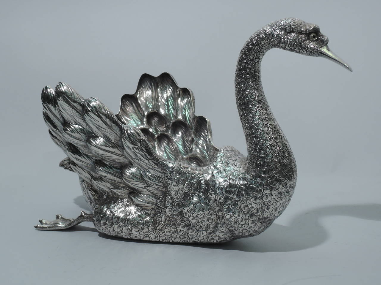 Sterling silver centerpiece bowl in form of swan. Made by Buccellai in Milan. Bird has scrolled neck and head, closed bill, and severe glass eyes, and is in glide mode with flipped back web feet. Feathers beautifully delineated, including the plumy