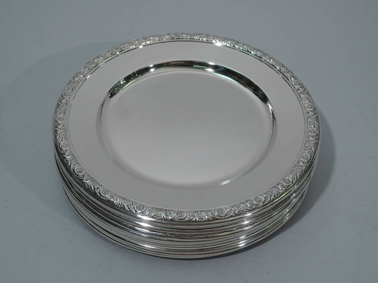 Set of 12 sterling silver bread-and-butter plates in Prelude pattern. Made by International in Meriden, Conn. Each: plain well. Rim has chased flowers and scrolls. Hallmark includes no. H576. Excellent condition.

Dimensions: H ¼ x D 6 in. Total