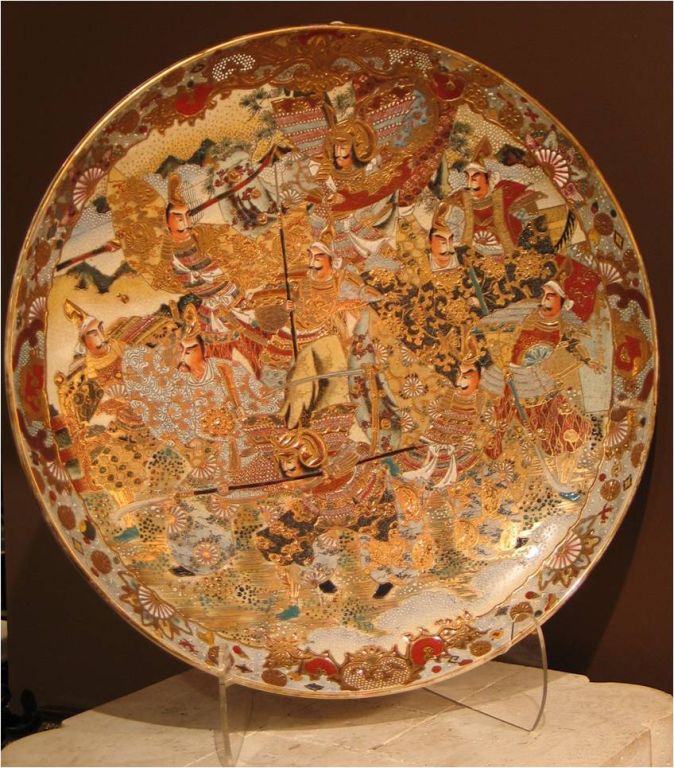 C21195   An oversize Japanese Satsuma charger c. 1870's. Signed example w/ elaborately conceived hand applied detailed enamel and gilt decoration overall.  <br />
            22 in. Dia.