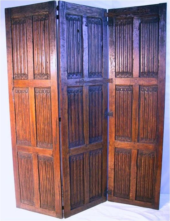 A c. 1600 three panel folding screen. Solid hand carved oak in a linenfold pattern. Paneled construction with multiple hand forged hinges and strapwork.<br />
72 in. H x 19.75 in. W ea panel = 59.25