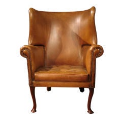 A 19th.c. English barrel back wing form arm chair