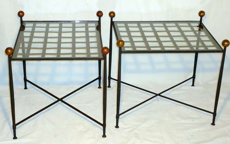 A classic and elegant pair of enameled wrought iron latticed top end tables from Salterini designed by Mario Papperzini. 
Cast and hammered wrought iron legs topped by antique bronze colored lacquered finials. 
The pair are ready for indoor or