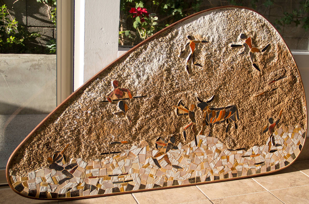 A mosaic wall piece of ceramic and glass tile figures on a sculpted background of granular oyster shell and a variety of differently toned sands and micas by American ceramicist Richard Hohenberg from 1958.
Hohenberg studied with Picasso's ceramic