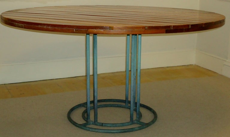Naval bronze table by Walter Lamb for Brown Jordan with a custom ordered Philippine mahogany top. The five foot top is rarely found the majority of the round tables measure three or four foot in diameter.

The last photo of this listing shows the