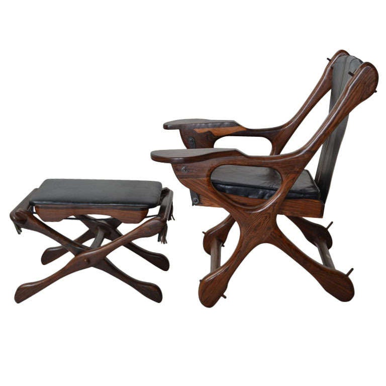 A Classic 20th century chair and ottoman from one of the great craftsman's workshops of Mexico: Senal, S.A., Don Shoemaker's tropical paradise in Michoacan, Mexico. 
This iconic chair with its suspended sling and organic bone like elements is