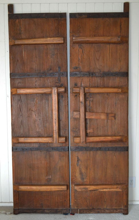 Antique Chinese doors of elm wood and iron from the Ching Dynasty (circa 1790).  Purchased in 1997 in China, these doors are not reproductions as is found in much of the market today.

Located in Indio, Calif.