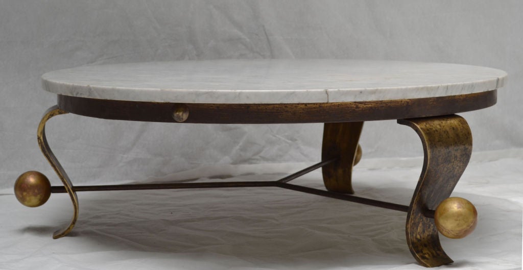 Impressive marble and gilt iron coffee table by Roberto and Mito Block.
This late 1940s or early 1950s coffee table with a circular Carrara marble top is much more impressive in person than in its photographs. 

The table is in excellent vintage