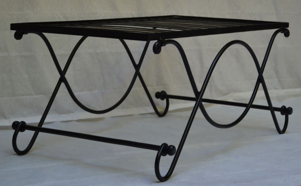 A 1950s French low wrought iron cocktail table with an opaque white glass insert, the table may be used indoors or outdoors and is in excellent condition.

